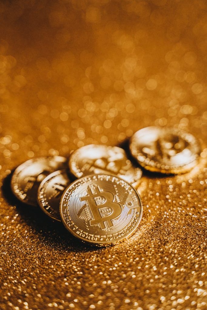 Close-up of Bitcoin coins on a shimmering gold background, symbolizing cryptocurrency and digital finance.